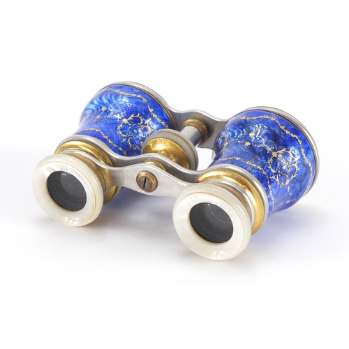 23 - Pair of brass and Mother of Pearl opera glasses, the guilloche enamelled jewelled barrels decorated ... 