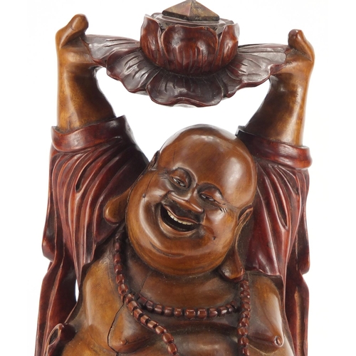 2181 - Chinese hardwood carving of Happy Buddha holding a lotus flower aloft, 39.5cm high