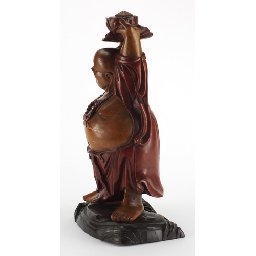 2181 - Chinese hardwood carving of Happy Buddha holding a lotus flower aloft, 39.5cm high