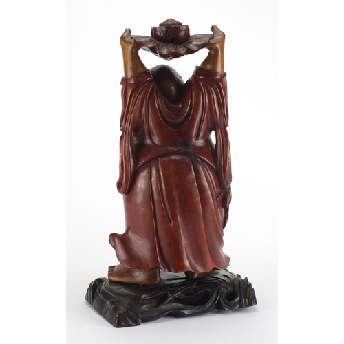 2181 - Chinese hardwood carving of Happy Buddha holding a lotus flower aloft, 39.5cm high