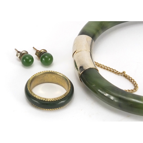 701 - Chinese spinach green jade jewellery suite comprising a bangle, pendant, pair of earrings and ring, ... 