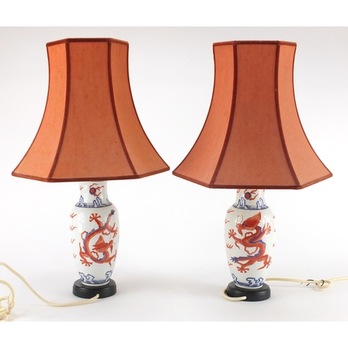 2286 - Pair of Chinese porcelain baluster lamps, hand painted with dragons with shades, each 46cm high