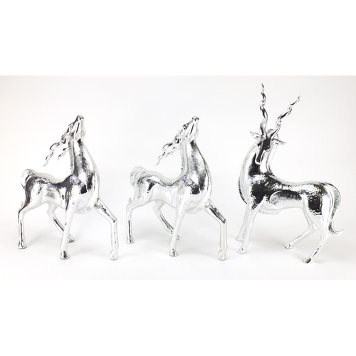 2277 - Three silvered models of standing gazelles, the largest 44cm high