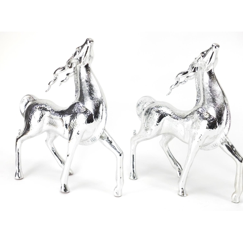 2277 - Three silvered models of standing gazelles, the largest 44cm high