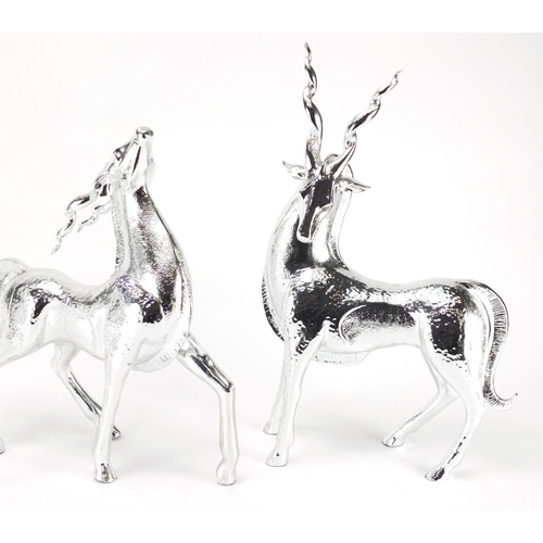 2277 - Three silvered models of standing gazelles, the largest 44cm high