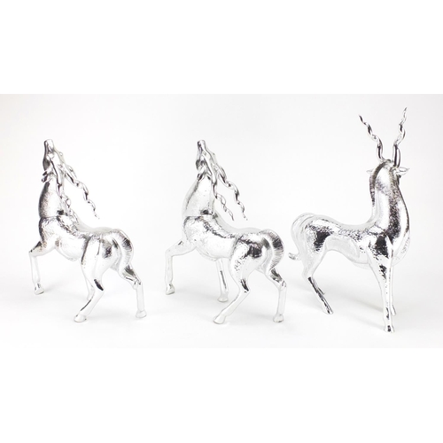 2277 - Three silvered models of standing gazelles, the largest 44cm high