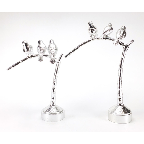 2281 - Two silvered models of three birds on a branch, the largest 51cm high