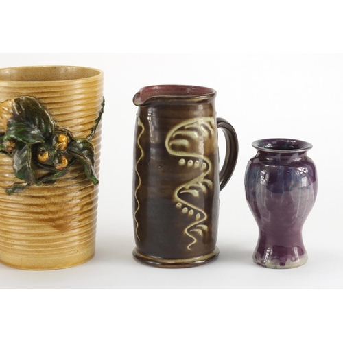 2355 - Art pottery including Bretby vase with a relief floral design and a purple glazed Baron baluster vas... 