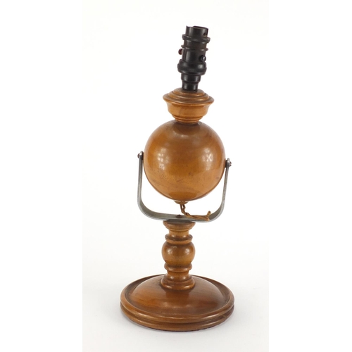 2275 - Carved wooden gimbal lamp with Bakelite fitting, 37cm high