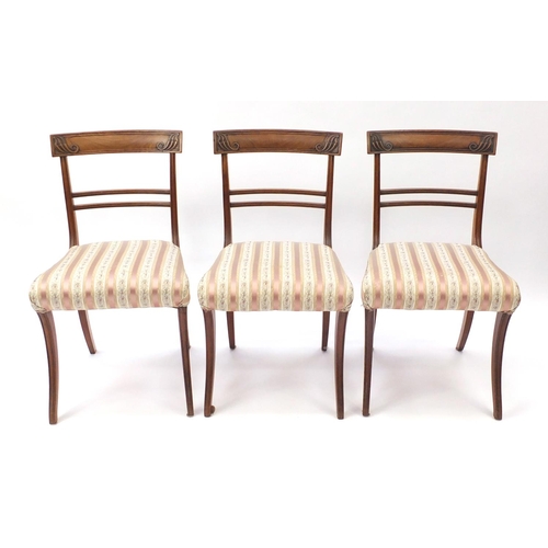 2101 - Set of six Regency mahogany dining chairs, with carved top rails and striped upholstered stuff over ... 