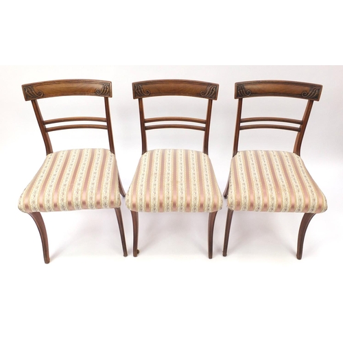 2101 - Set of six Regency mahogany dining chairs, with carved top rails and striped upholstered stuff over ... 