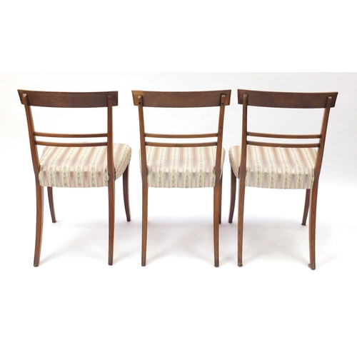 2101 - Set of six Regency mahogany dining chairs, with carved top rails and striped upholstered stuff over ... 