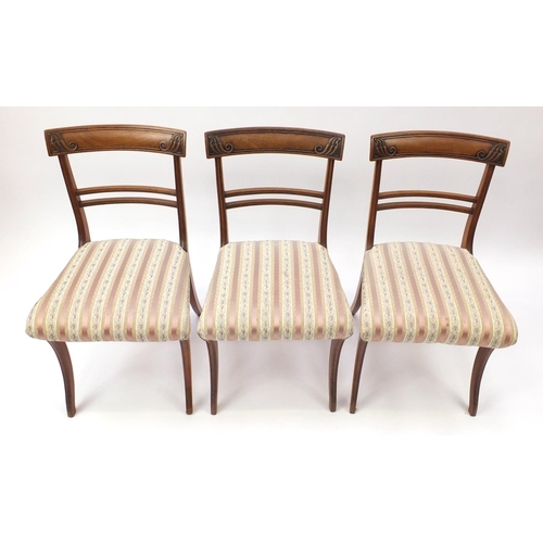 2101 - Set of six Regency mahogany dining chairs, with carved top rails and striped upholstered stuff over ... 