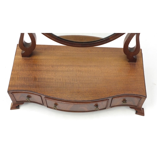 2146 - Oval mahogany toilet mirror, the serpentine fronted base with three drawers, 72cm high