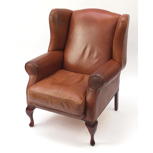 2024 - Mahogany framed brown leather wingback armchair, 104cm high