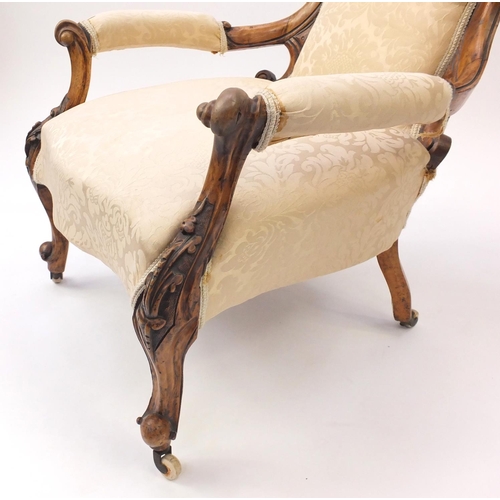 2097 - Victorian carved walnut gentleman's chair, with beige floral upholstery, 101.5cm high