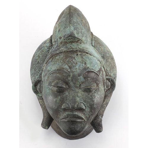 2327 - Patinated brass face mask of an Afrcian female's head, 36cm high