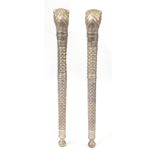 2126 - Pair of silvered metal lion head torch design columns, each 104cm in length