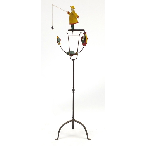 2128 - Novelty hand painted wrought iron fisherman design wind operated garden ornament, with tripod base, ... 