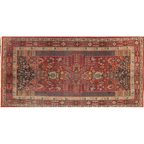2035 - Rectangular Persian rug, having an all over floral design, onto a predominately red ground, 267cm x ... 
