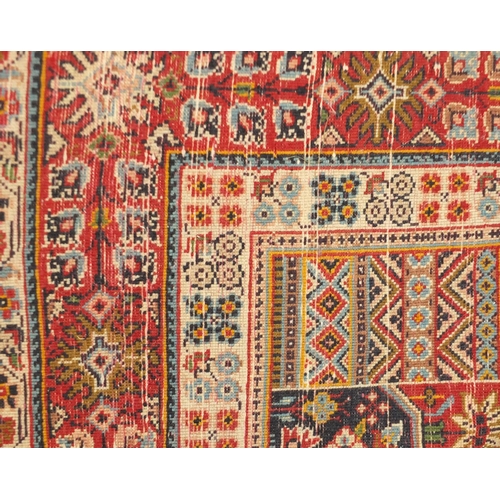 2035 - Rectangular Persian rug, having an all over floral design, onto a predominately red ground, 267cm x ... 