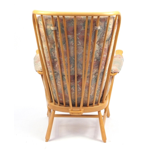 2141 - Ercol light elm Evergreen stick back armchair, with floral button back upholstery, 102cm high