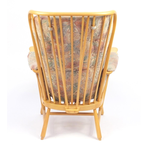 2140 - Ercol light elm Evergreen stick back armchair, with floral button back upholstery, 102cm high