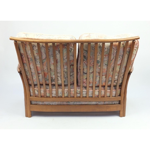 2075 - Ercol Renaissance two seater settee, with floral upholstered lift off cushions, approximately 140cm ... 