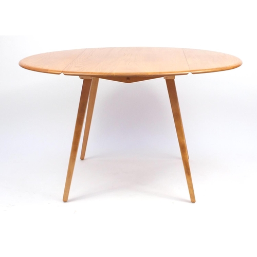2009 - Ercol light elm Windsor table and four chairs, each chair 88cm high, the table 72cm H x 63cm W x 104... 