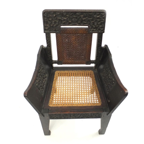 2107 - Antique Anglo Indian carved hardwood occasional chair, with cane back and seat, 91.5cm high