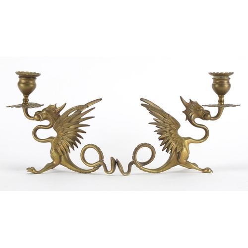 2318 - Pair of brass Griffin design candlesticks, each 20cm in length