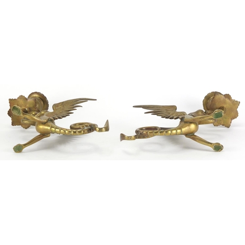 2318 - Pair of brass Griffin design candlesticks, each 20cm in length