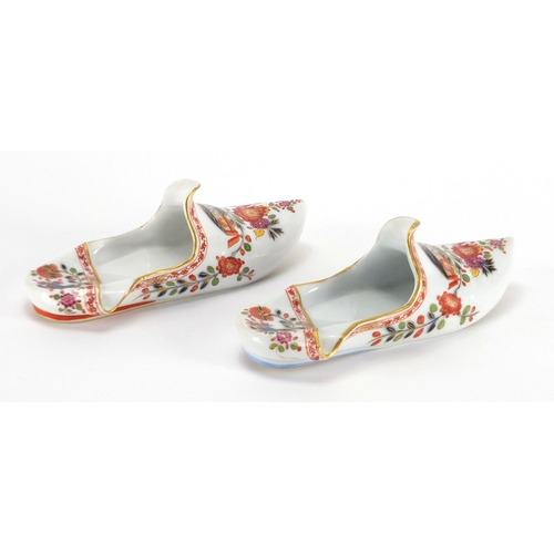 2218 - Pair of Meissen porcelain slippers, each hand painted and gilded with flowers, cross sword marks to ... 