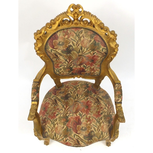 2048 - Ornate French gilt wood open armchair with floral upholstery, carved with rosettes and scrolls, 110c... 