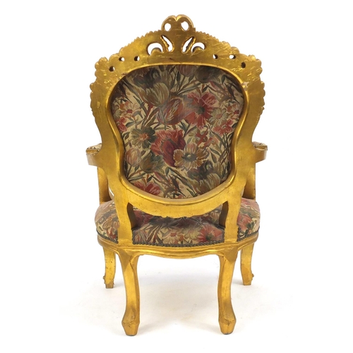 2048 - Ornate French gilt wood open armchair with floral upholstery, carved with rosettes and scrolls, 110c... 