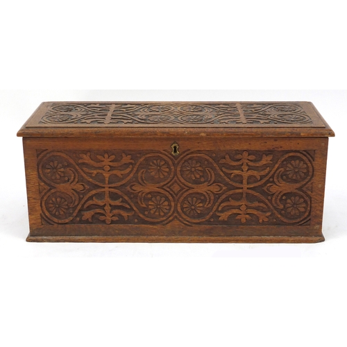 2127 - Rectangular oak chest with ring turned handles, carved with flower heads and stylised foliage, 26cm ... 