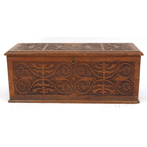 2127 - Rectangular oak chest with ring turned handles, carved with flower heads and stylised foliage, 26cm ... 