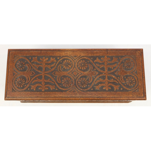 2127 - Rectangular oak chest with ring turned handles, carved with flower heads and stylised foliage, 26cm ... 