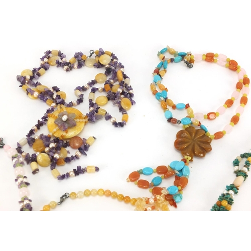 2830 - Seven semi precious carved stone necklaces including amethyst and quartz