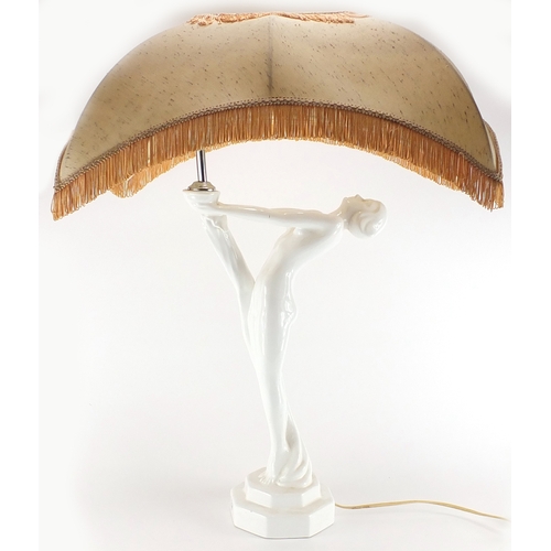 2346 - White glazed porcelain lamp and shade, in the form of a nude Art Deco female with out stretched arms... 