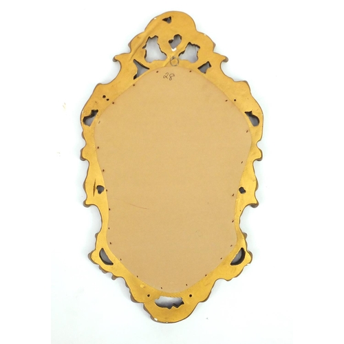 34 - Ornate gilt framed cartouche shaped mirror, 73cm x 43cm
