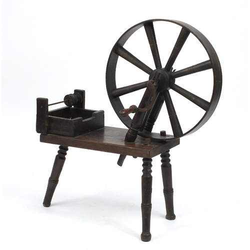 54 - Antique oak three legged spinning wheel, 82cm high