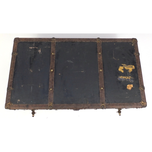 6 - Vintage leather and brass bound trunk, with remnants of shipping labels, 35cm H x 103cm W x 57cm D