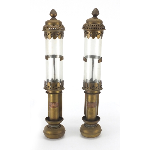 2274 - Pair of GWR brass candle holders with glass shades, each 38cm high