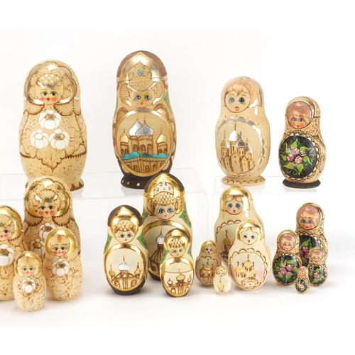 2274 - Five Russian hand painted and pokerwork Matryoshka stacking dolls including a Father Christmas desig... 