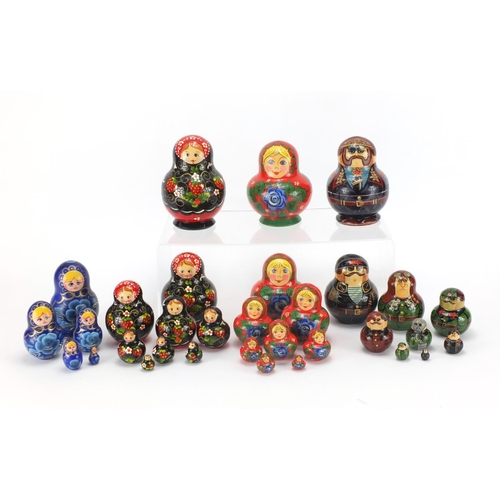 2252 - Four Russian hand painted Matryoshka stacking dolls, two inscribed to the bases, the largest 13cm hi... 