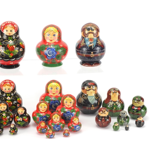 2252 - Four Russian hand painted Matryoshka stacking dolls, two inscribed to the bases, the largest 13cm hi... 