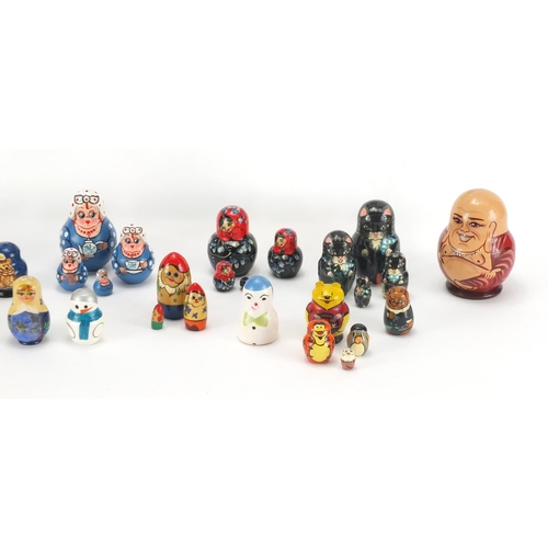 2187 - Russian hand painted dolls, some Matryoshka stacking together with a musical box, some inscribed to ... 