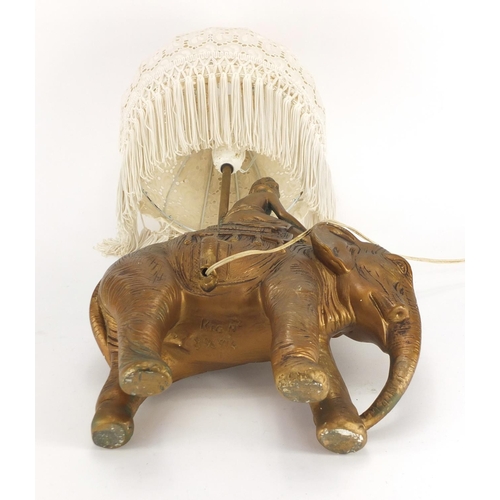 2248 - Hand painted plaster figure on elephant back lamp, with shade, 60cm high
