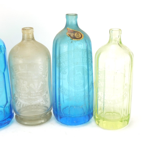 2104 - Six vintage advertising soda syphon bottles including Ellis's, H Gould's, Bolingbroke Aerated and Sw... 